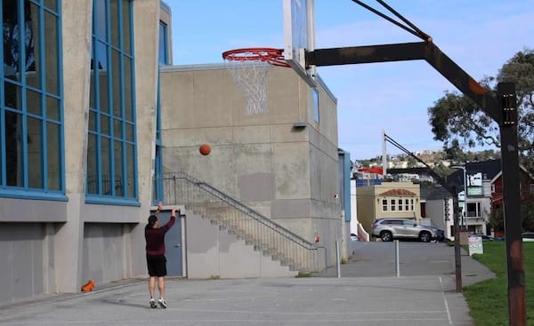 Man plays basketball.