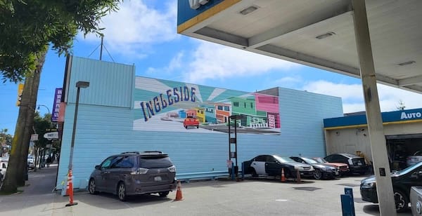 Mural at gas station depicting a hill with homes and the word "Ingleside"