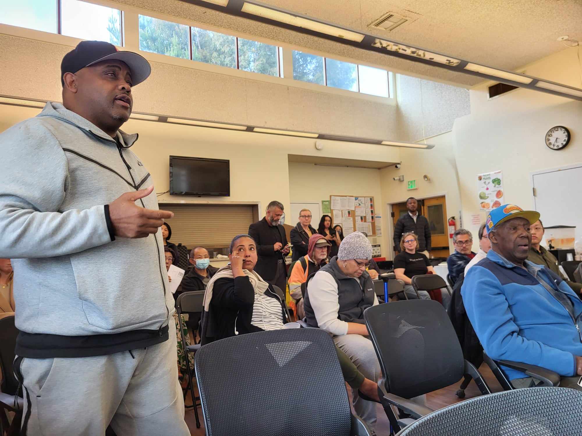 Man speaks at meeting.