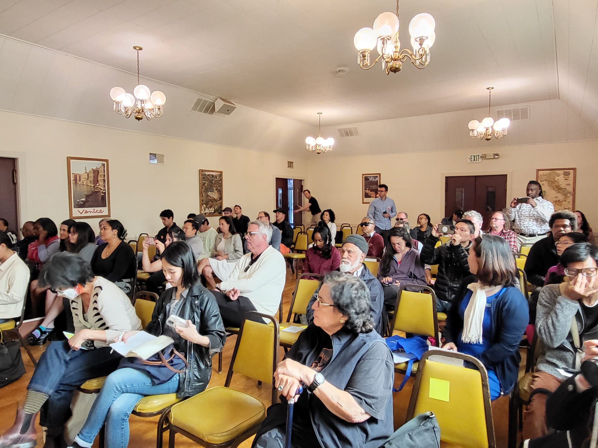 People seated in a large room.