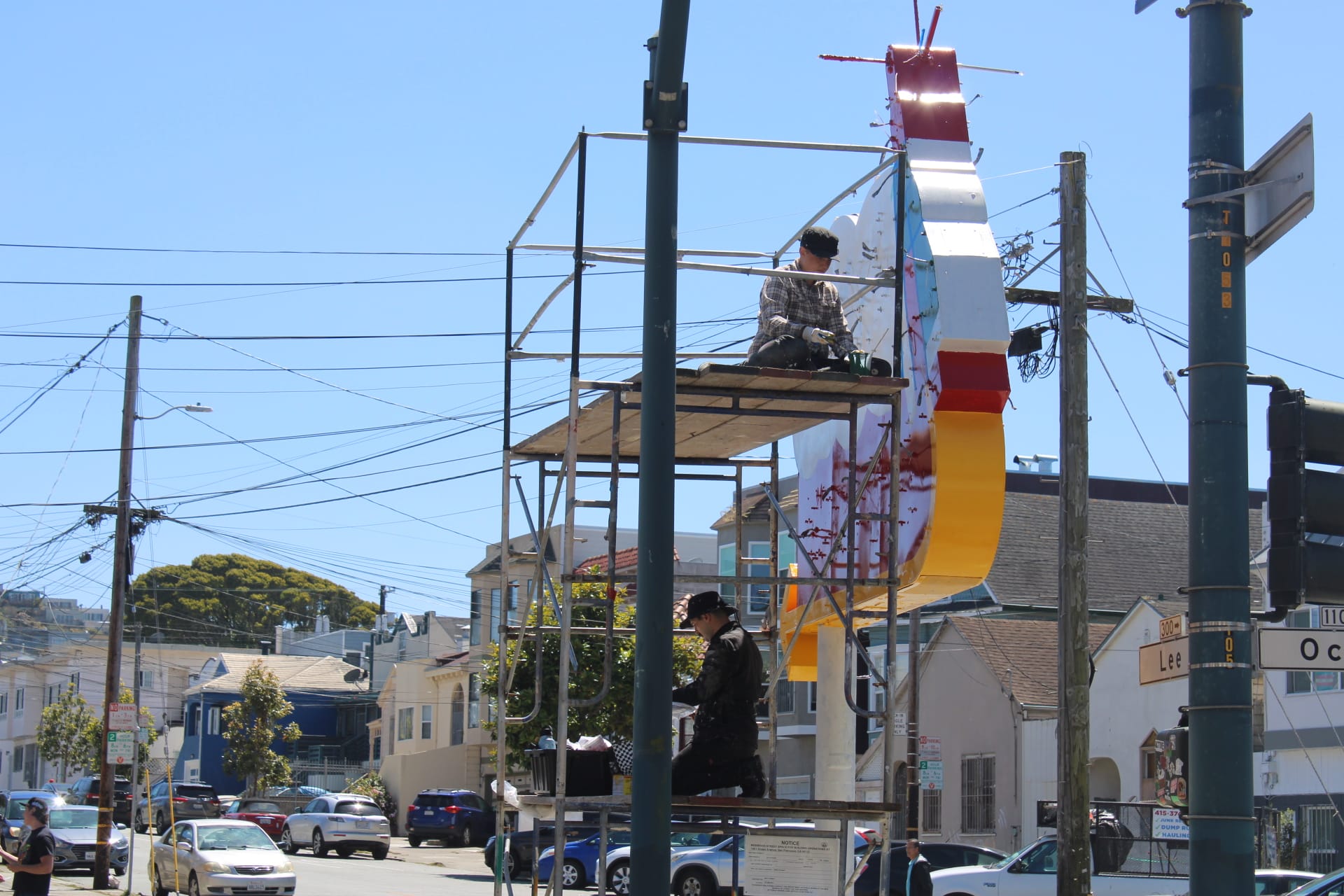 People work on sign.