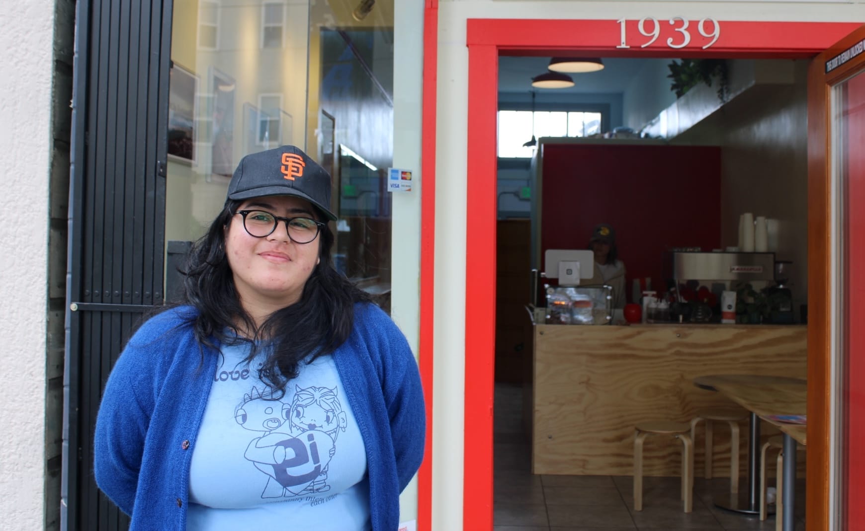 Woman in front of storefront.