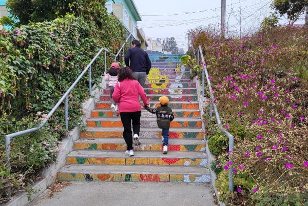 People walk up staircase.