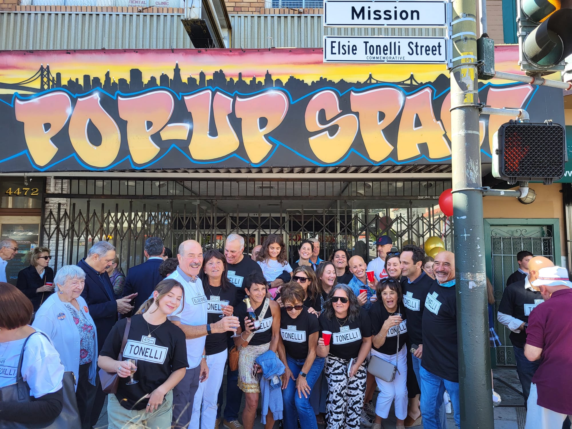 People in front of street sign.