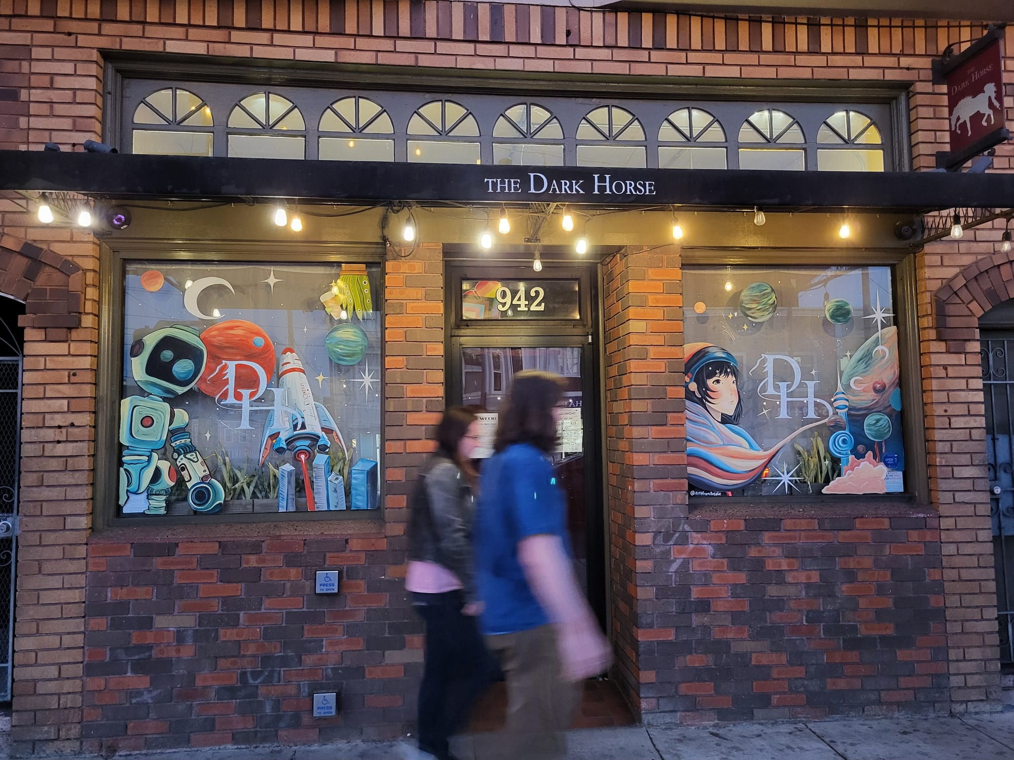 Storefront exterior with pedestrians passing.