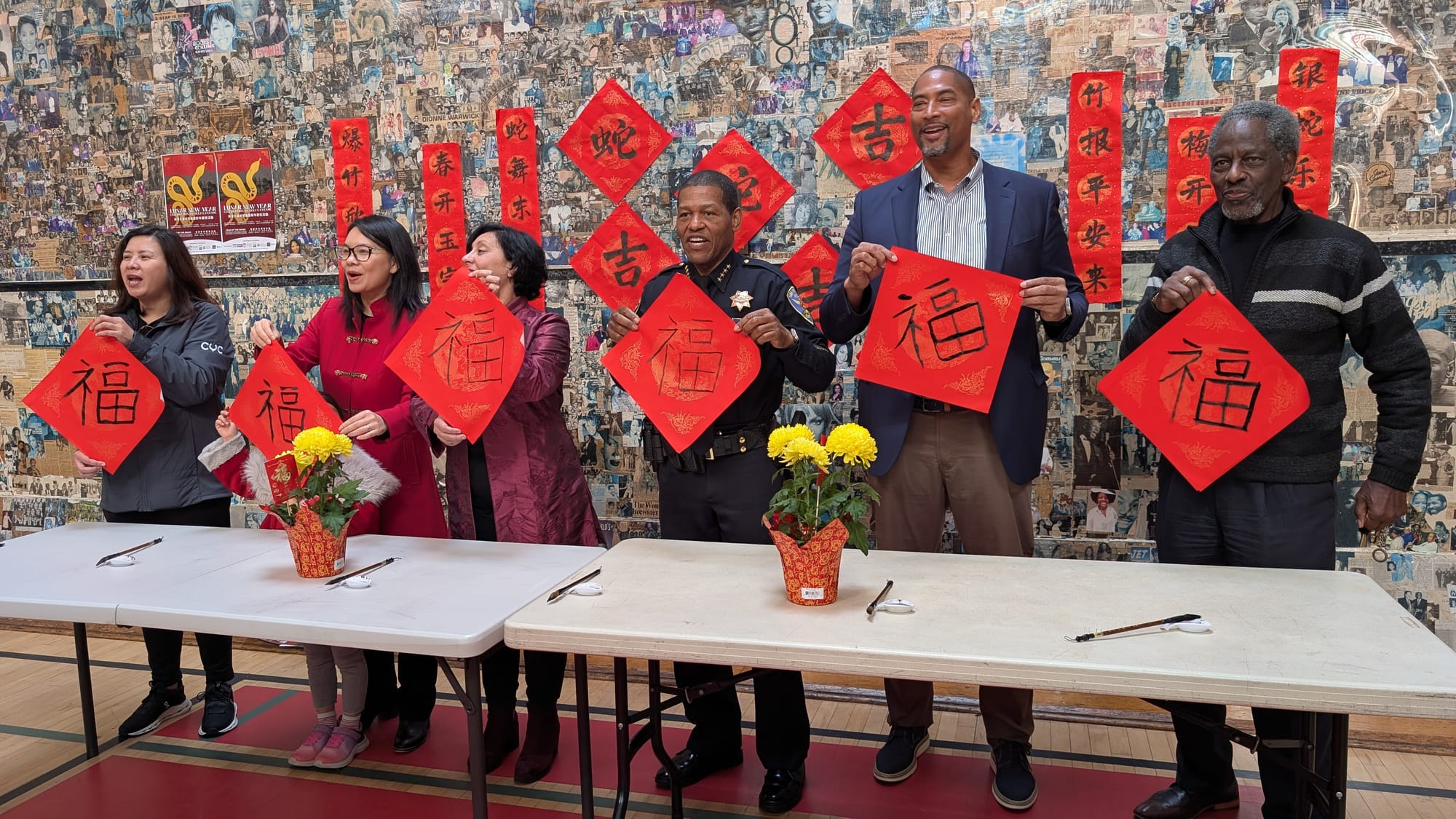 Officials hold up caligraphy.