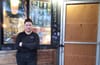 Woman in front of storefront.