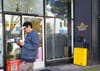 Man walks by storefont